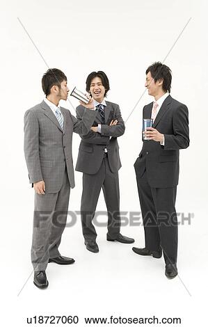 Stock Image - Three businessmen drinking and talking. Fotosearch