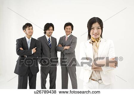Three businessmen looking at businesswoman View Large Photo Image Stock Photo - Three businessmen looking at businesswoman. Fotosearch