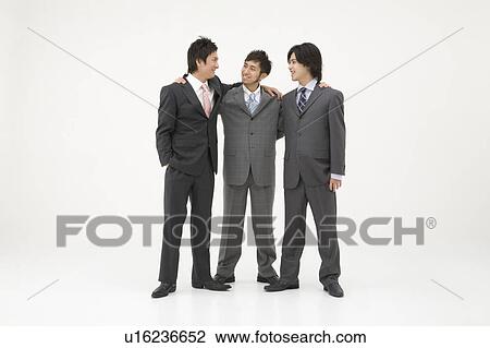 Three businessmen standing with arms around each other View Large Photo Image Stock Image - Three businessmen standing with arms around each other. Fotosearch