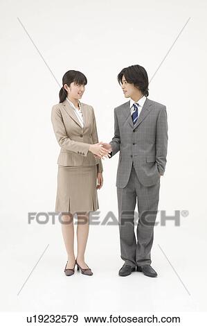 Stock Photo - Two business people shaking hands. Fotosearch