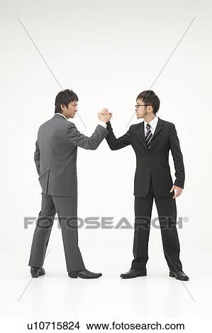 Picture - Two businessmen shaking hands. Fotosearch