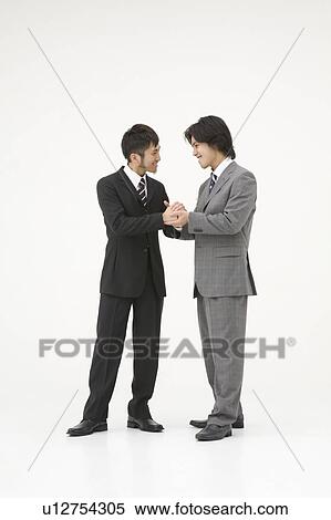 Stock Photography - Two businessmen shaking hands. Fotosearch
