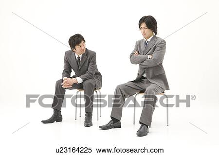 Stock Photography - Two businessmen sitting. Fotosearch