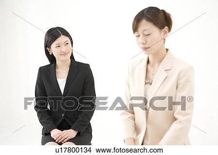 Picture - Two businesswomen sitting. Fotosearch