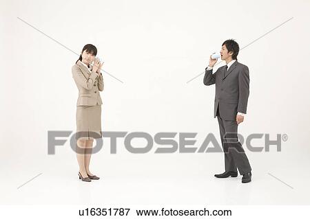 Stock Photo - Two young business people talking with string and cups. Fotosearch