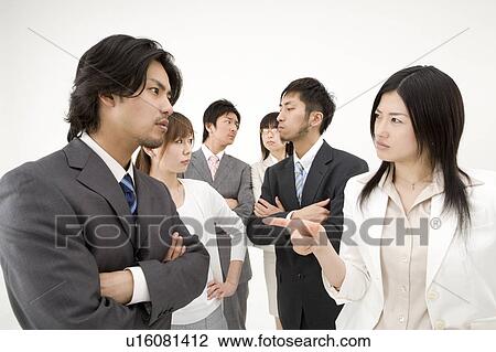 Stock Image - Business people glaring at each other. Fotosearch