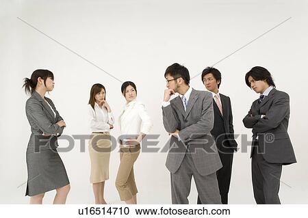 Stock Image - Business people glaring at each other. Fotosearch