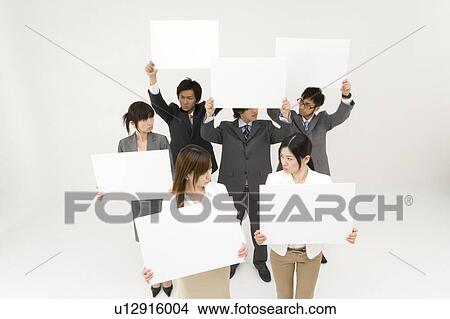 Picture - Business people holding blank placards. Fotosearch