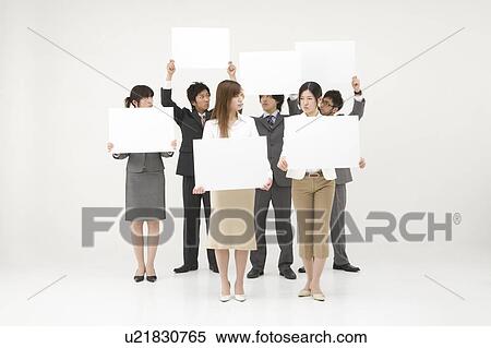 Stock Photography - Business people holding blank placards. Fotosearch
