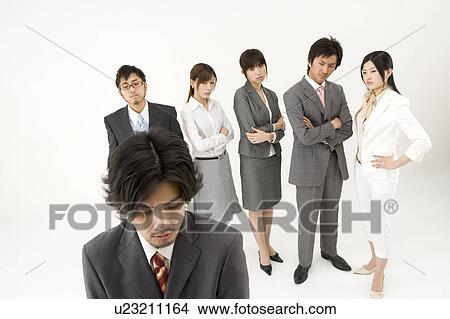 Businessman excluded from group of business people View Large Photo Image Picture - Businessman excluded from group of business people. Fotosearch