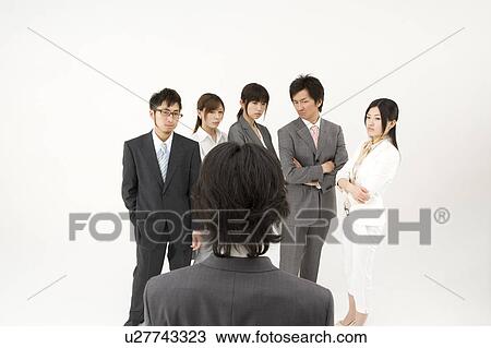 Stock Image - Businessman excluded from group of business people. Fotosearch