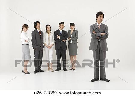 Stock Photo - Businessman excluded from group of business people. Fotosearch