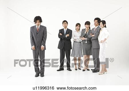 Businessman excluded from group of business people View Large Photo Image Stock Photograph - Businessman excluded from group of business people. Fotosearch
