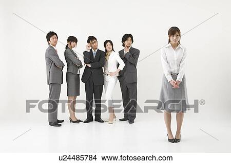 Picture - Businesswoman excluded from group of business people. Fotosearch