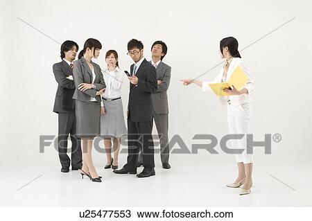 Stock Image - Businesswoman excluded from group of business people. Fotosearch