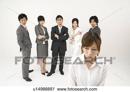 Businesswoman excluded from group of business people View Large Photo Image Stock Photo - Businesswoman excluded from group of business people. Fotosearch
