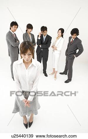 Stock Photo - Businesswoman excluded from group of business people. Fotosearch