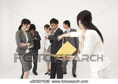 Stock Photograph - Businesswoman excluded from group of business people. Fotosearch