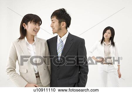 Businesswoman looking at couple View Large Photo Image Stock Image - Businesswoman looking at couple. Fotosearch
