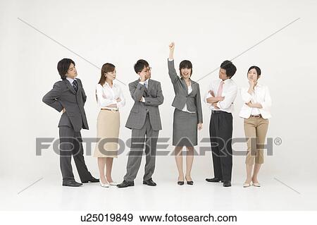 Businesswoman standing out from the group View Large Photo Image Stock Photo - Businesswoman standing out from the group. Fotosearch