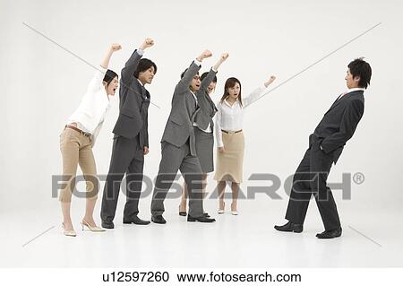 Stock Image - Group of business people shouting at colleague. Fotosearch