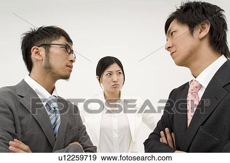 Stock Photo - Three business people glaring at each other. Fotosearch
