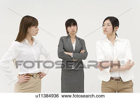 Three businesswomen glaring at each other View Large Photo Image Stock Photograph - Three businesswomen glaring at each other. Fotosearch