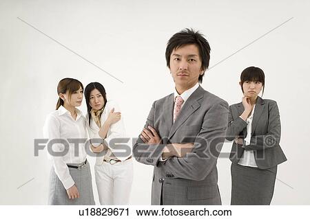 Three businesswomen looking at businessman View Large Photo Image Stock Image - Three businesswomen looking at businessman. Fotosearch