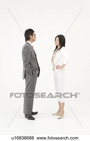 Two business people glaring at each other View Large Photo Image Stock Photo - Two business people glaring at each other. Fotosearch