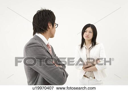 Two business people glaring at each other View Large Photo Image Stock Photo - Two business people glaring at each other. Fotosearch