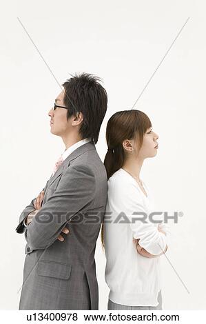 Two business people standing back to back View Large Photo Image Stock Photo - Two business people standing back to back. Fotosearch