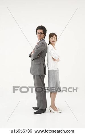 Stock Photograph - Two business people standing back to back. Fotosearch