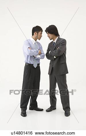 Stock Photograph - Two businessmen glaring at each other. Fotosearch