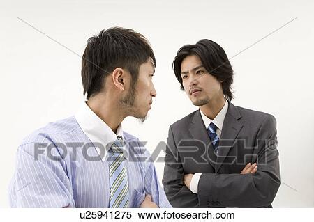 Two businessmen glaring at each other View Large Photo Image Stock Photography - Two businessmen glaring at each other. Fotosearch