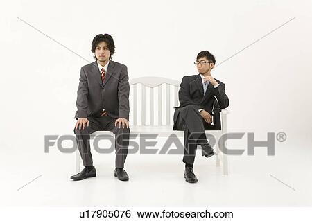 Stock Photograph - Two businessmen sitting on bench. Fotosearch