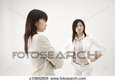 Stock Photo - Two businesswomen glaring at each other. Fotosearch