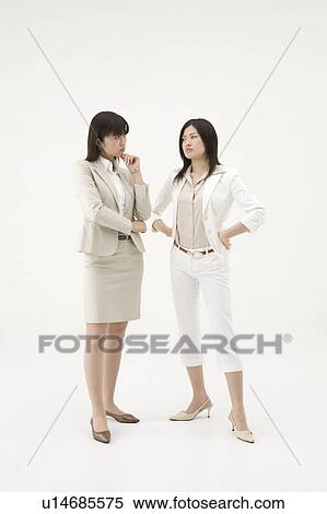 Stock Photography - Two businesswomen glaring at each other. Fotosearch