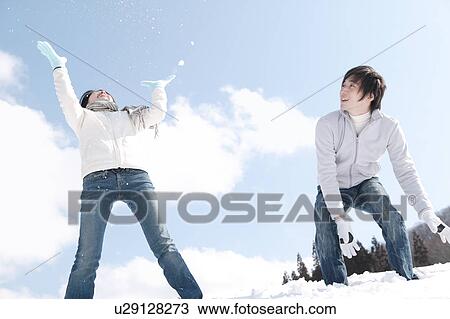 Young couple playing with snow View Large Photo Image Stock Image - Young couple playing with snow. Fotosearch