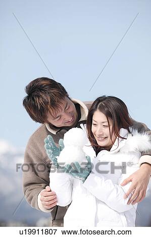 Young couple playing with snow View Large Photo Image Stock Photo - Young couple playing with snow. Fotosearch
