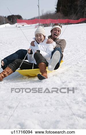 Young couple sledding View Large Photo Image Picture - Young couple sledding. Fotosearch