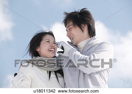 Stock Image - Young couple smiling. Fotosearch