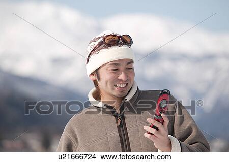 Picture - Young man using mobile phone. Fotosearch