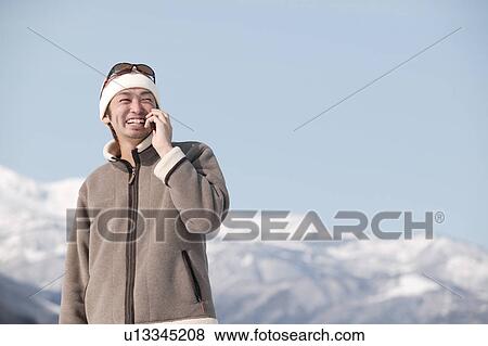 Stock Photo - Young man using mobile phone. Fotosearch