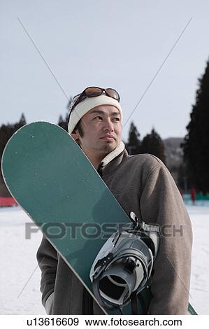 Young man with snowboard View Large Photo Image Stock Photo - Young man with snowboard. Fotosearch