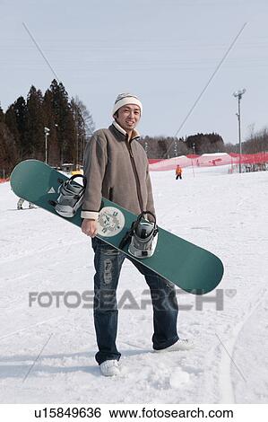 Stock Photograph - Young man with snowboard. Fotosearch