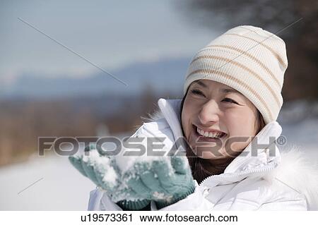 Young woman playing with snow View Large Photo Image Stock Image - Young woman playing with snow. Fotosearch