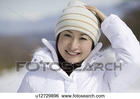 Stock Photograph - Young woman smiling looking at camera. Fotosearch