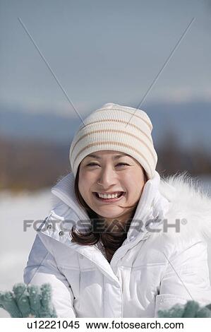 Stock Photography - Young woman smiling looking at camera. Fotosearch