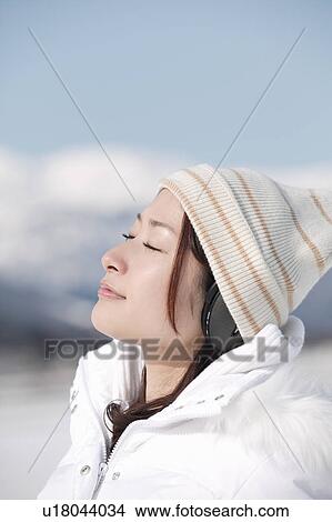 Picture - Young woman wearing headphones. Fotosearch