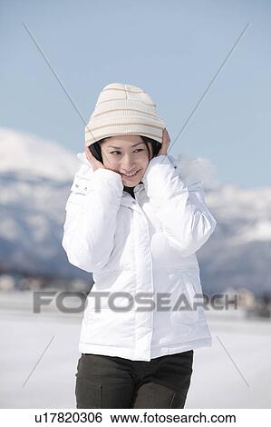 Stock Photograph - Young woman wearing headphones. Fotosearch